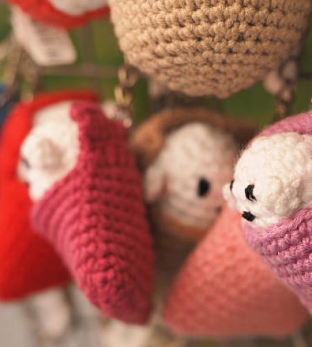 Vibrant market showcasing handcrafted plush keychains in various colors.